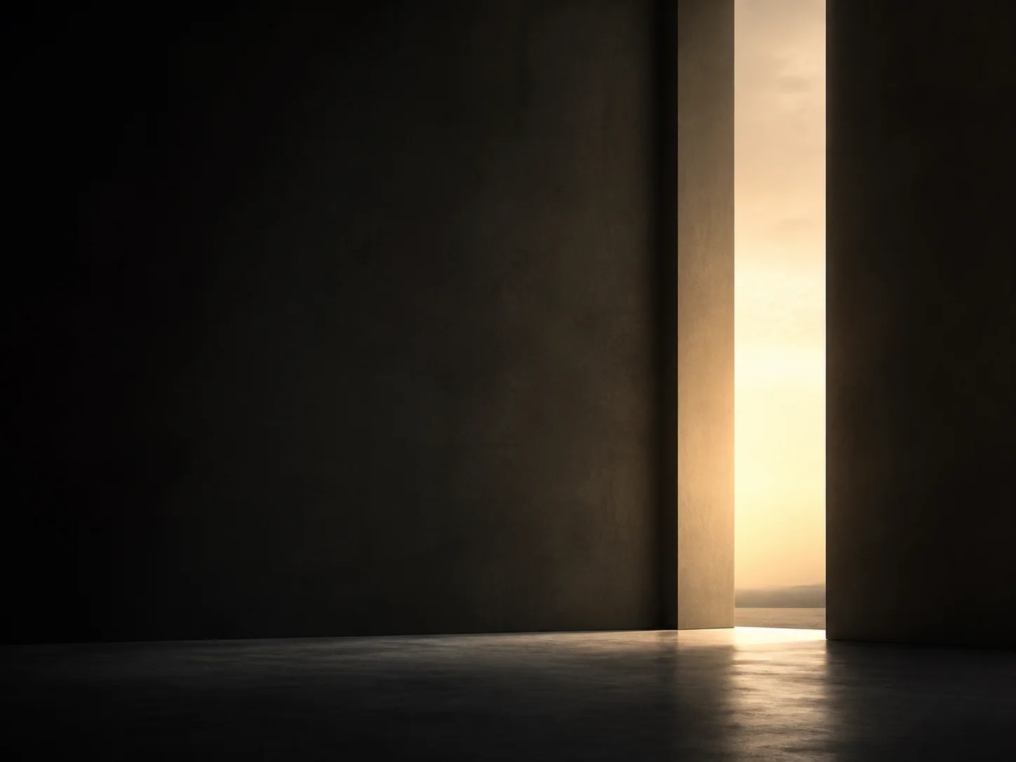 A narrow illuminated threshold opening in a dark wall