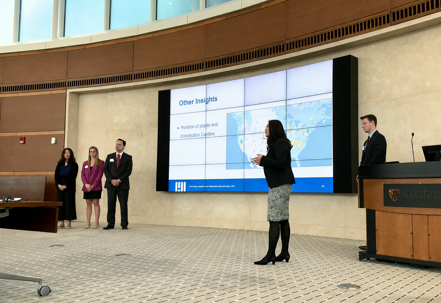 Kaitan presenting a case on a university stage
