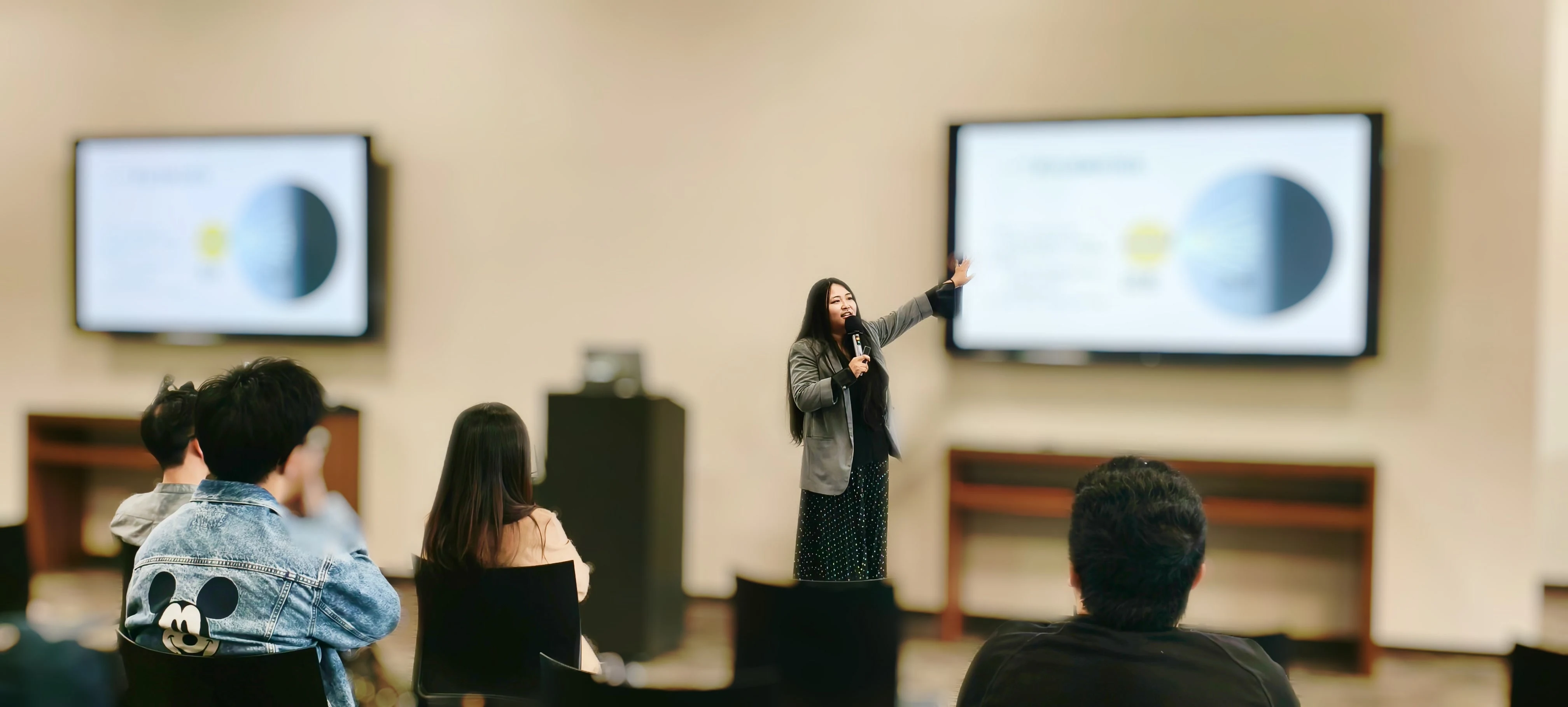 A wide view of Kaitan speaking about staying grounded amid anxiety about the AI era at Stanford University